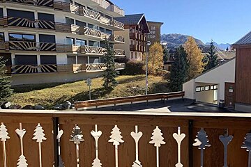 A balcony with a view of a building that says la cite