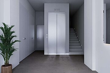 A modern, minimalist hallway with a silver elevator, softly lit stairs, and a potted plant. White walls and a grey floor define this sleek interior.