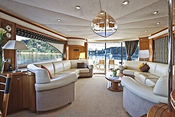 A living room on a boat with a couch and a table