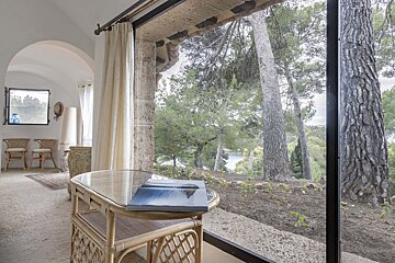A book sits on a table in front of a window
