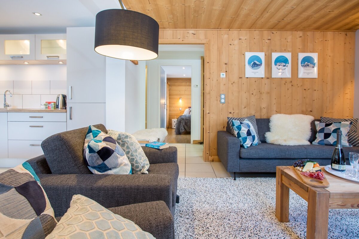 A living room with a couch a chair and a table