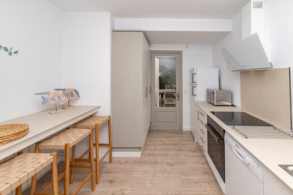 A kitchen with a stove top oven and a microwave