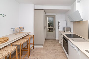 A kitchen with a stove top oven and a microwave