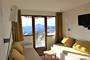 A living room with a couch and a flat screen tv
