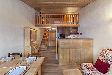 A living room with a staircase leading up to the second floor