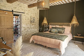 A bedroom with a bed made in provence by janssens immobilier