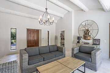 A living room with a couch and two chairs