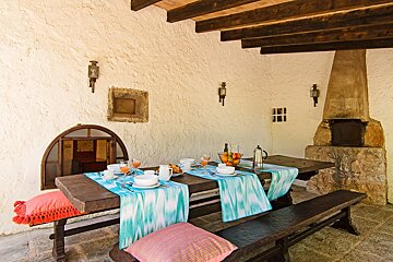 A wooden table with a blue and white table runner