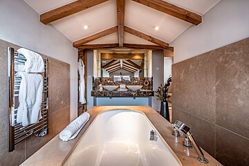 A bathroom with a bathtub and two sinks