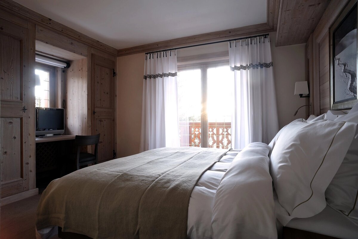 A bedroom with a large bed and a television