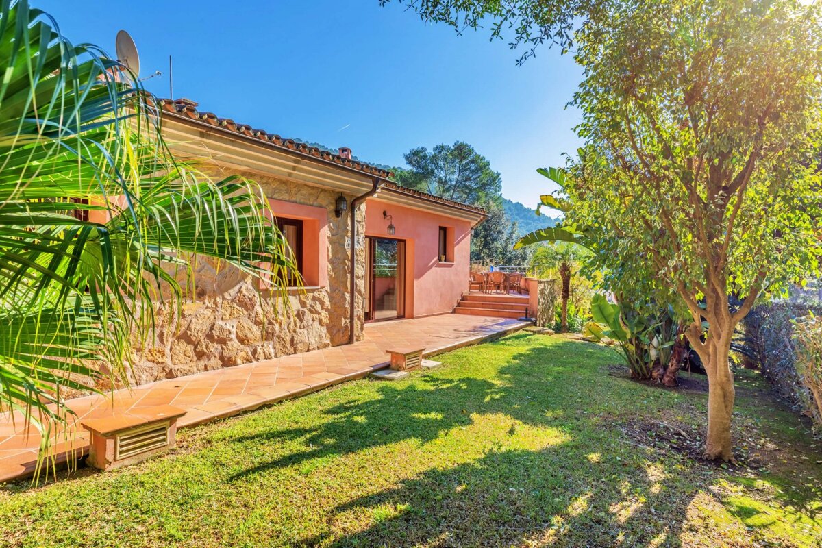 A house with a large lawn in front of it