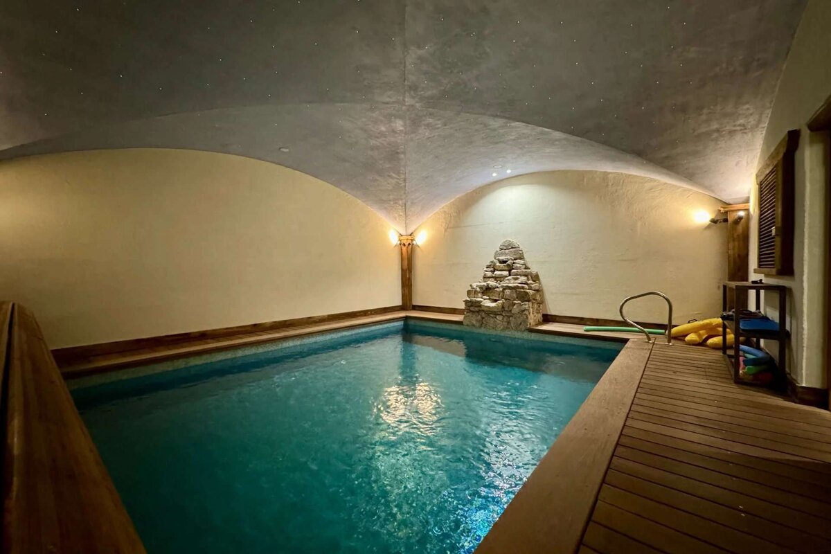 A large indoor swimming pool with a vaulted ceiling