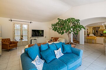 A living room with a blue couch and a brown chair