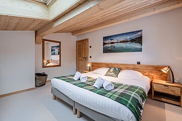A bedroom with a bed and a pillow with the number 6 on it