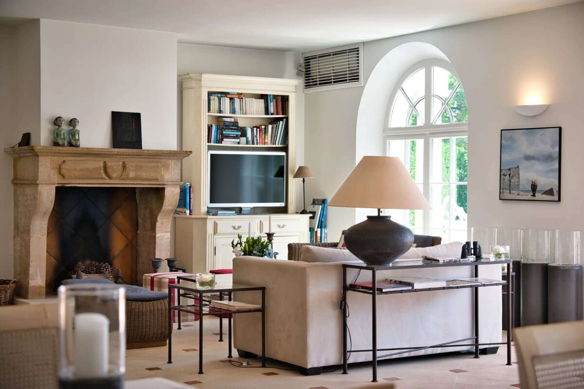 A living room with a fireplace and a flat screen tv