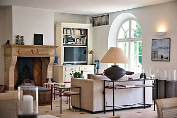 A living room with a fireplace and a flat screen tv