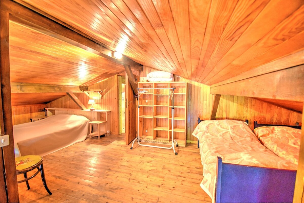 A bedroom with two beds and a closet