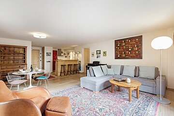 A living room with a couch and a rug