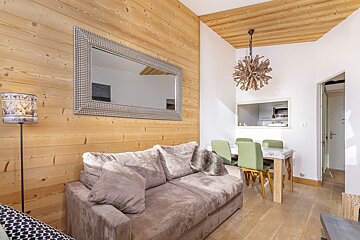 A living room with a couch and a mirror