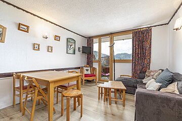 A living room with a couch a table and chairs
