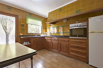 A kitchen with wooden cabinets and a white refrigerator