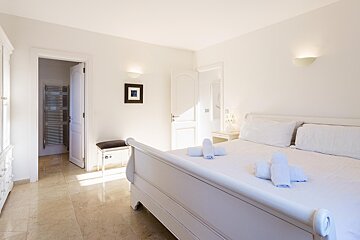 A bedroom with a bed and a picture on the wall