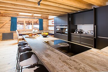 A kitchen with black cabinets and a stove top oven
