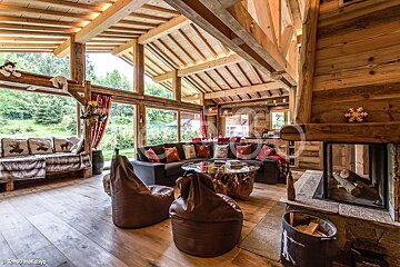 A living room with a couch and bean bag chairs and a fireplace