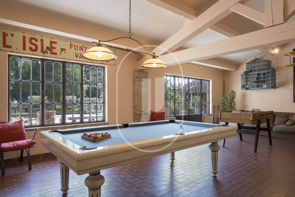 A pool table in a room with a sign above it that says l' isle