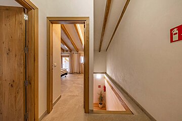 A hallway with a fire extinguisher on the wall