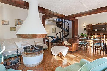 A living room with a fireplace and a spiral staircase