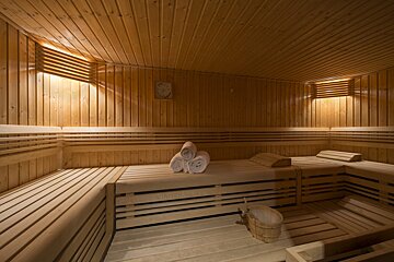 A wooden sauna with a clock on the wall