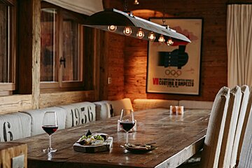 A dining room table with a poster on the wall that says 1956