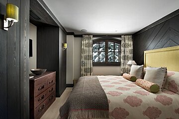 A bedroom with a large bed and a window
