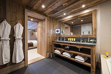 A bathroom with two sinks and a large mirror