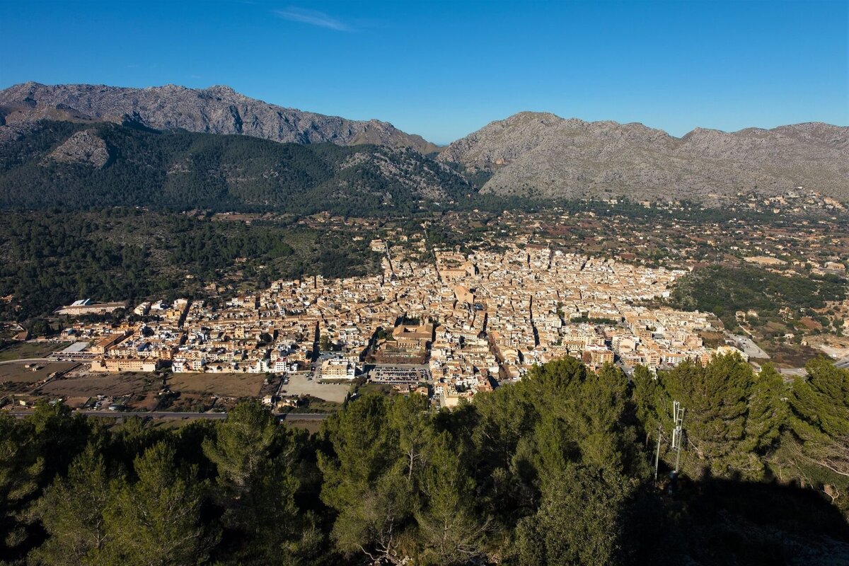 An aerial view of a city with mountains in the background