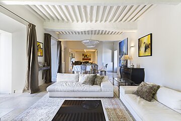 A living room with a white couch and a black coffee table