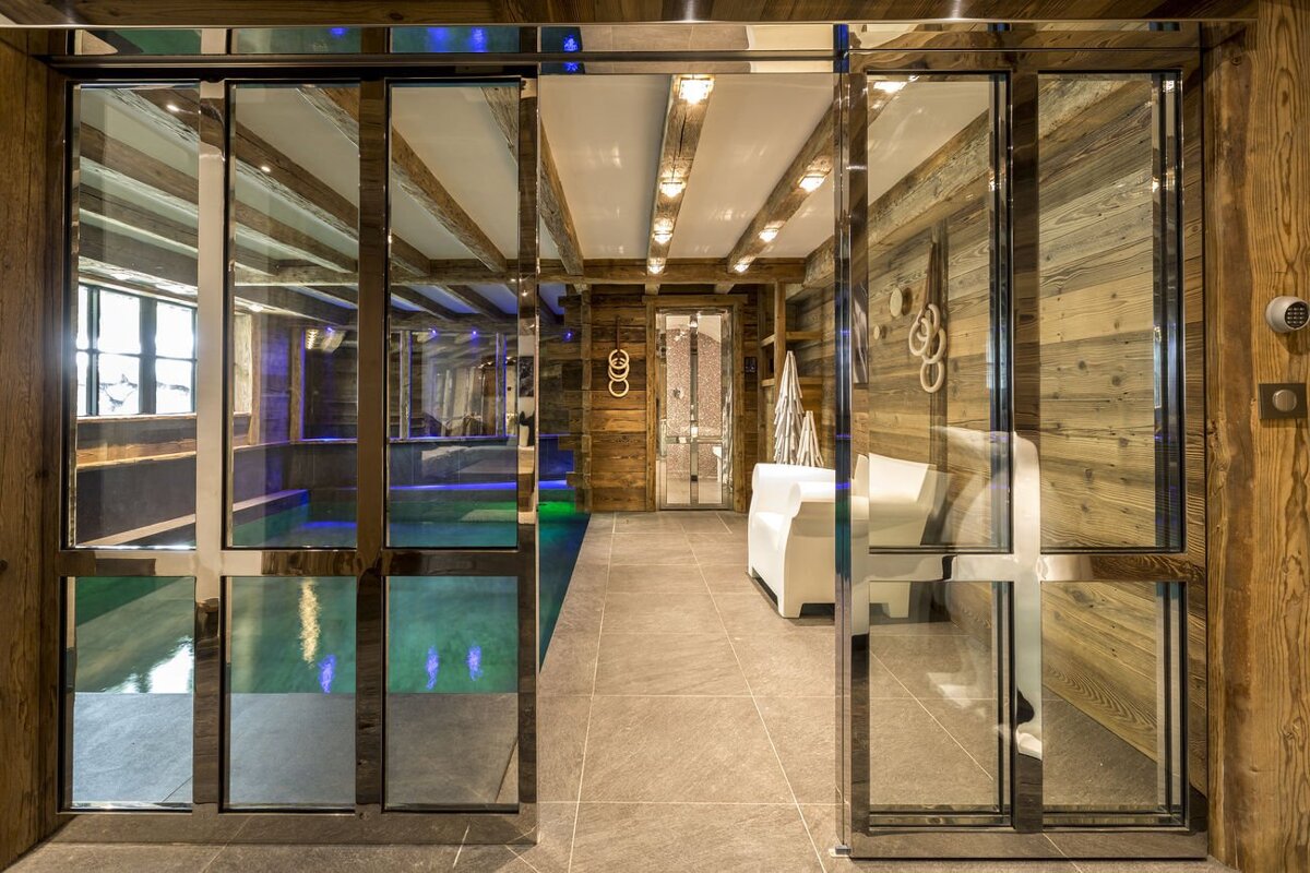 A sliding glass door leads to a swimming pool