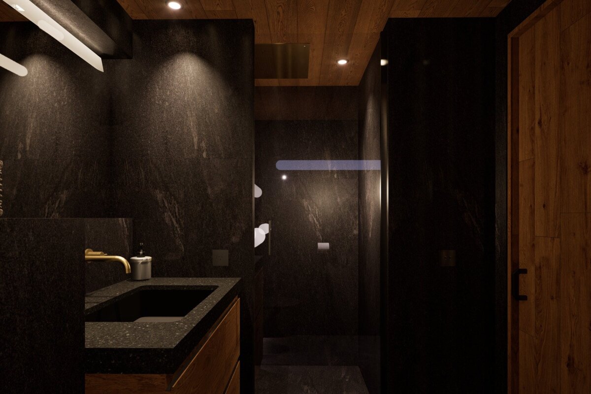 Sleek dark bathroom with granite walls, wooden ceiling, and warm lighting. Features a modern black sink, gold faucet, and glass shower enclosure.