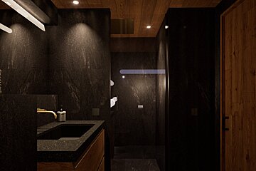 A bathroom with a black sink and wooden cabinets