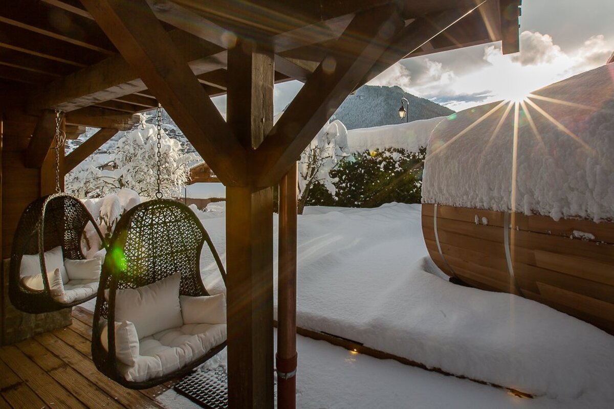 The sun is shining through the clouds above the snow