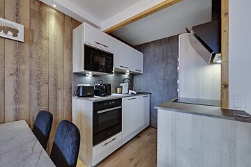 A kitchen with a toaster oven and a microwave