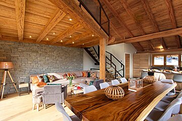 A living room with a wooden table and chairs