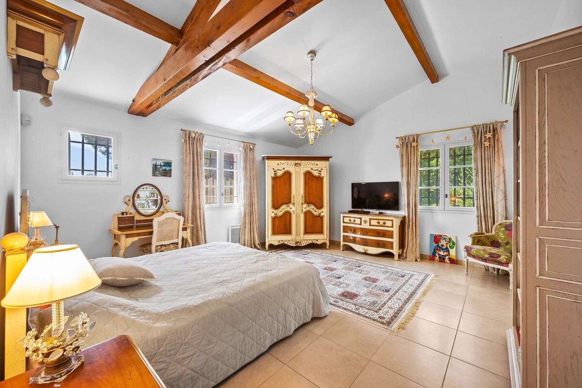 A bedroom with a bed dresser and television