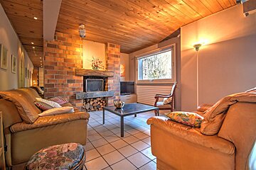 A living room with a fireplace and a couch