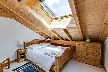A bedroom with a bed and a dresser with the word terro on the bottom