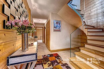 A staircase with a poster on the wall that says chamonix