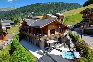 A large house with a hot tub in front of it