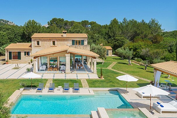 A large house with a large swimming pool in front of it