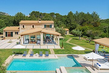A large house with a large swimming pool in front of it